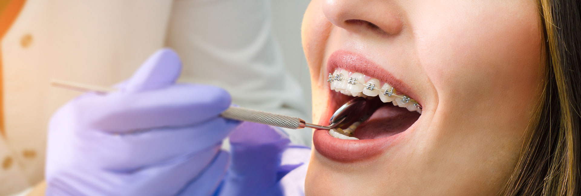 Dentist checking patient dental braces