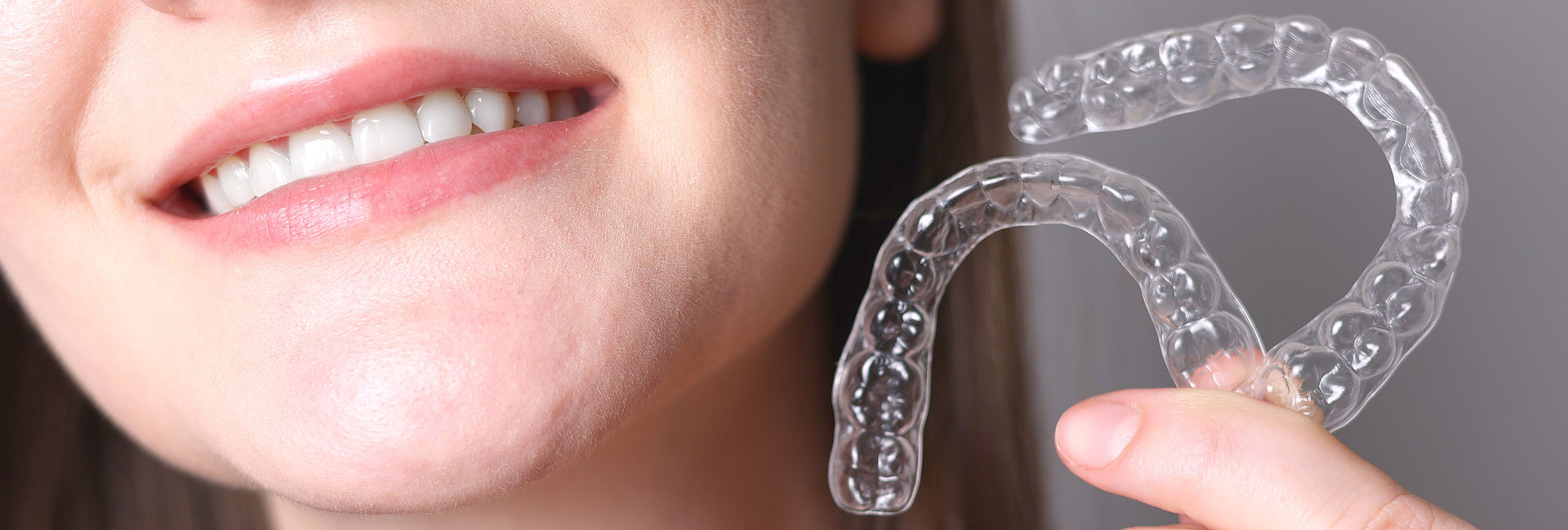 Woman holding a clear aligners